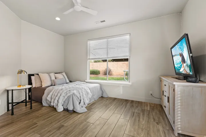 Bedroom featuring light wood-type flooring, a ceiling fan, and recessed lighting