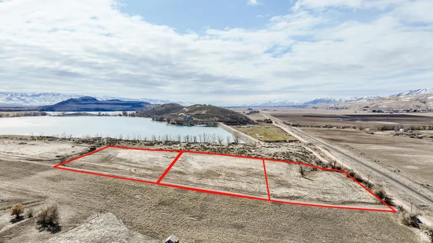 View of property location with property parcel outlined and a water and mountain view