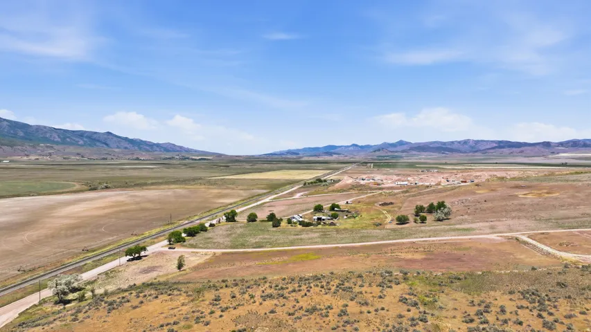 Expansive rural landscape featuring a single-family home