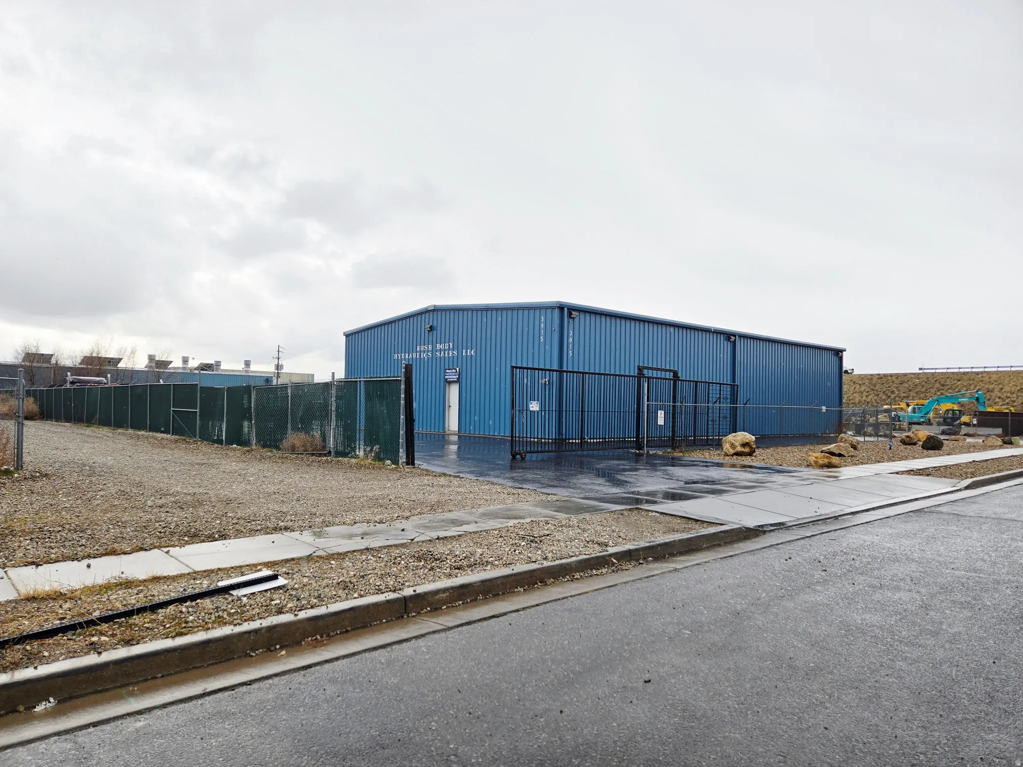 View of building exterior with an outbuilding