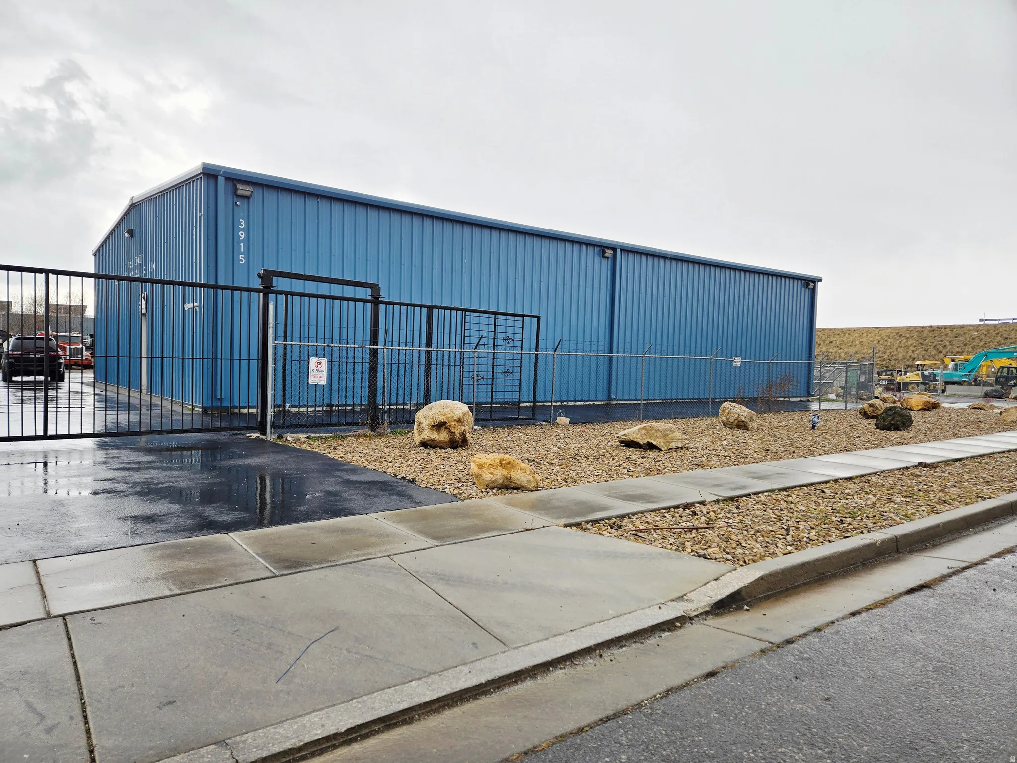 View of outbuilding featuring a gate