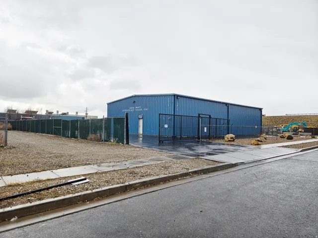 View of building exterior with an outbuilding