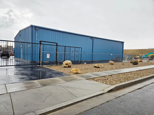 View of outbuilding featuring a gate