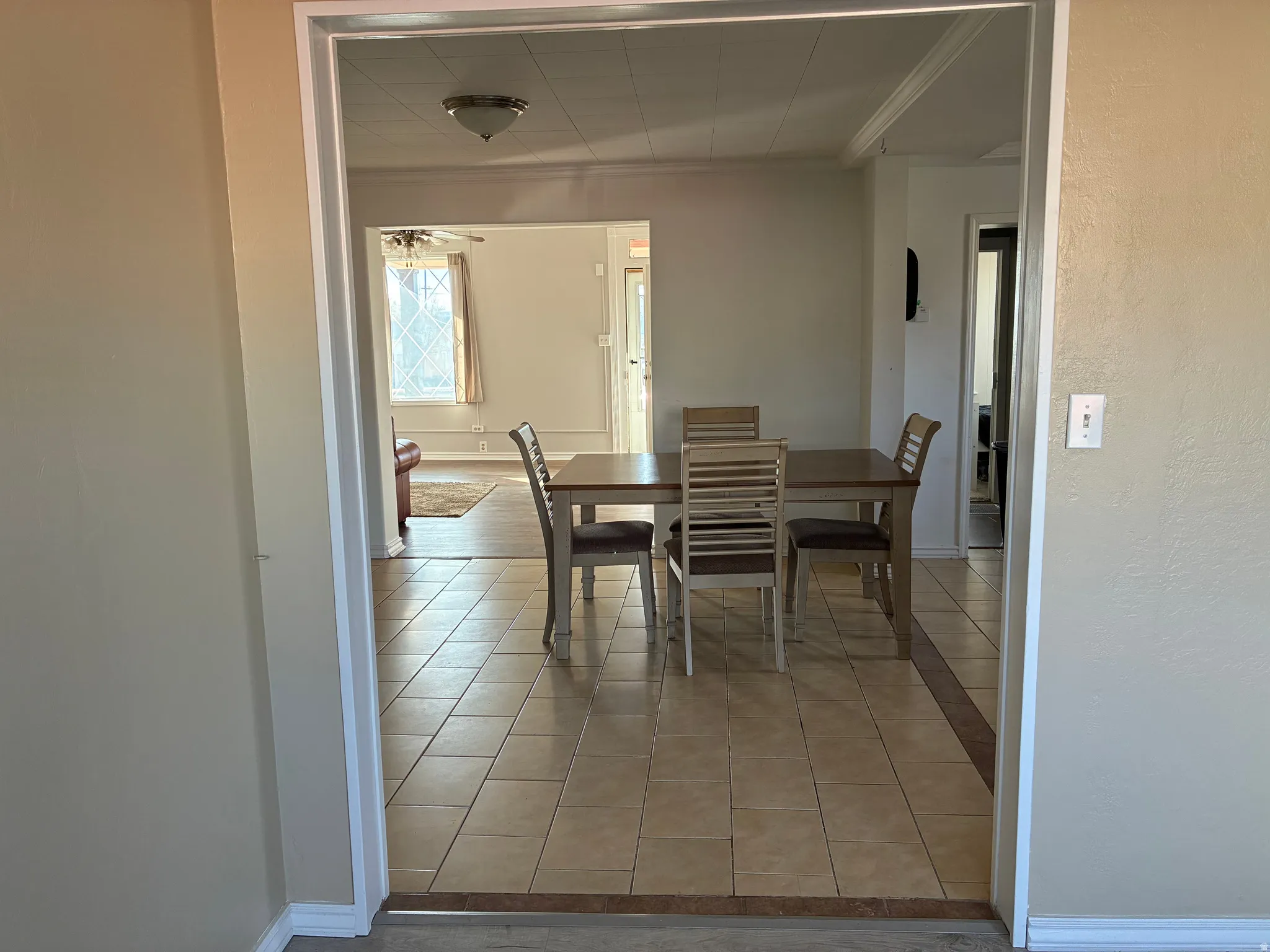 Dining area with light tile patterned flooring