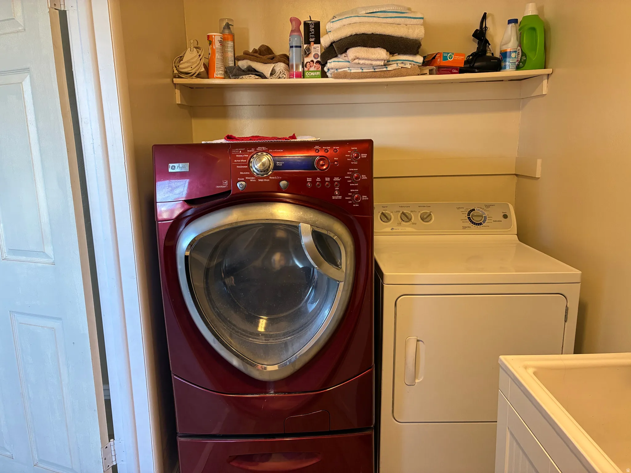 Laundry area featuring washing machine and dryer which will remain