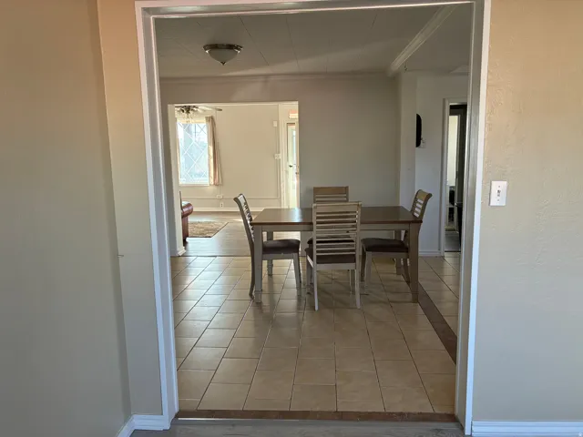 Dining area with light tile patterned flooring
