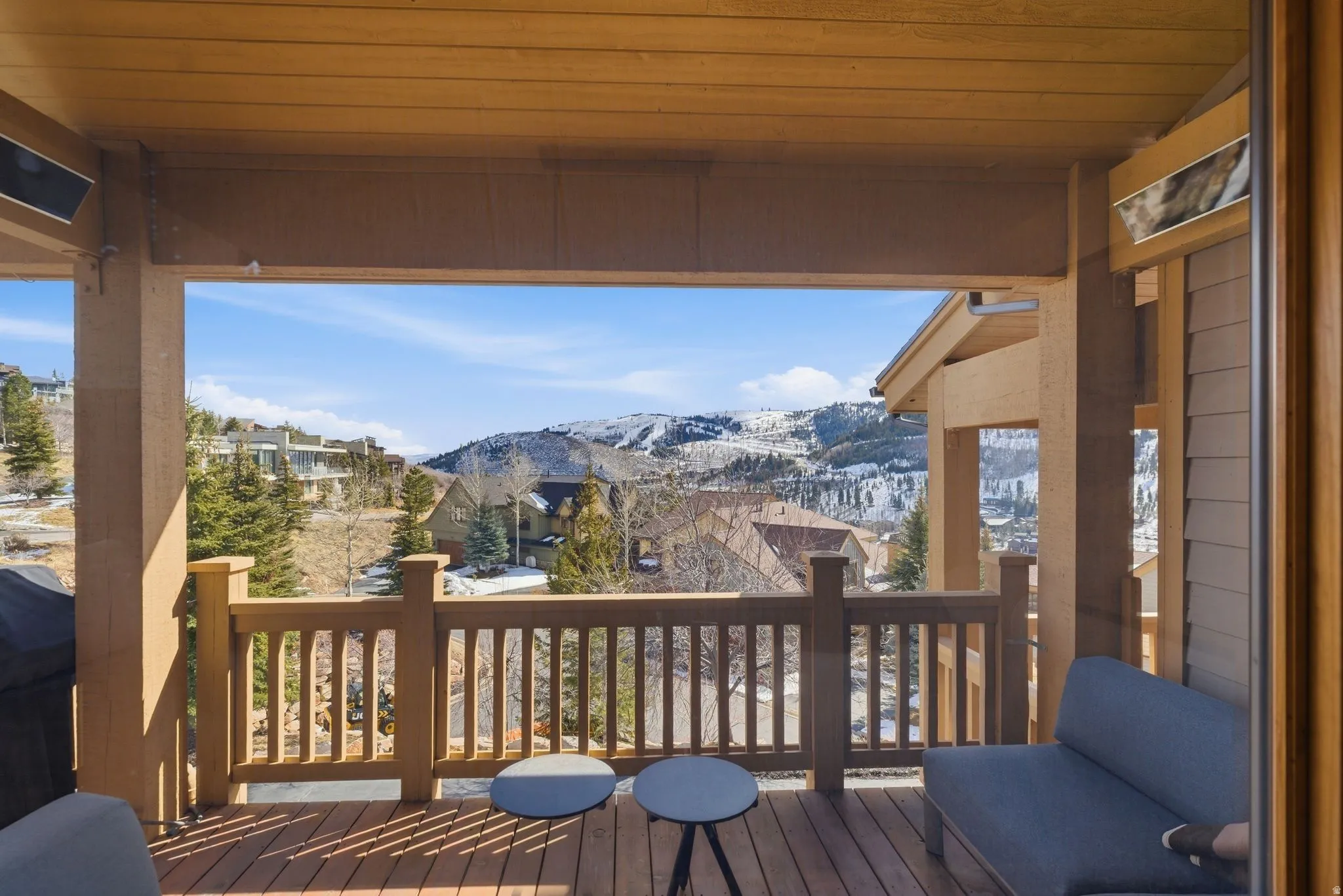 Covered outdoor deck with wood-finish flooring and railing