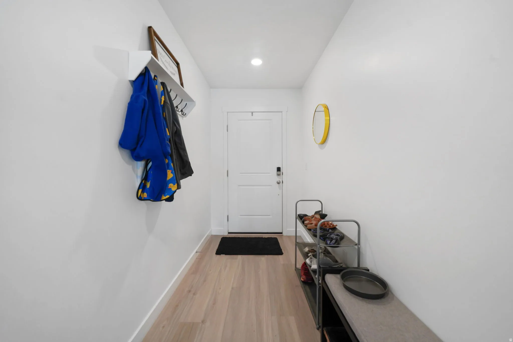 Doorway featuring wood finished floors and recessed lighting