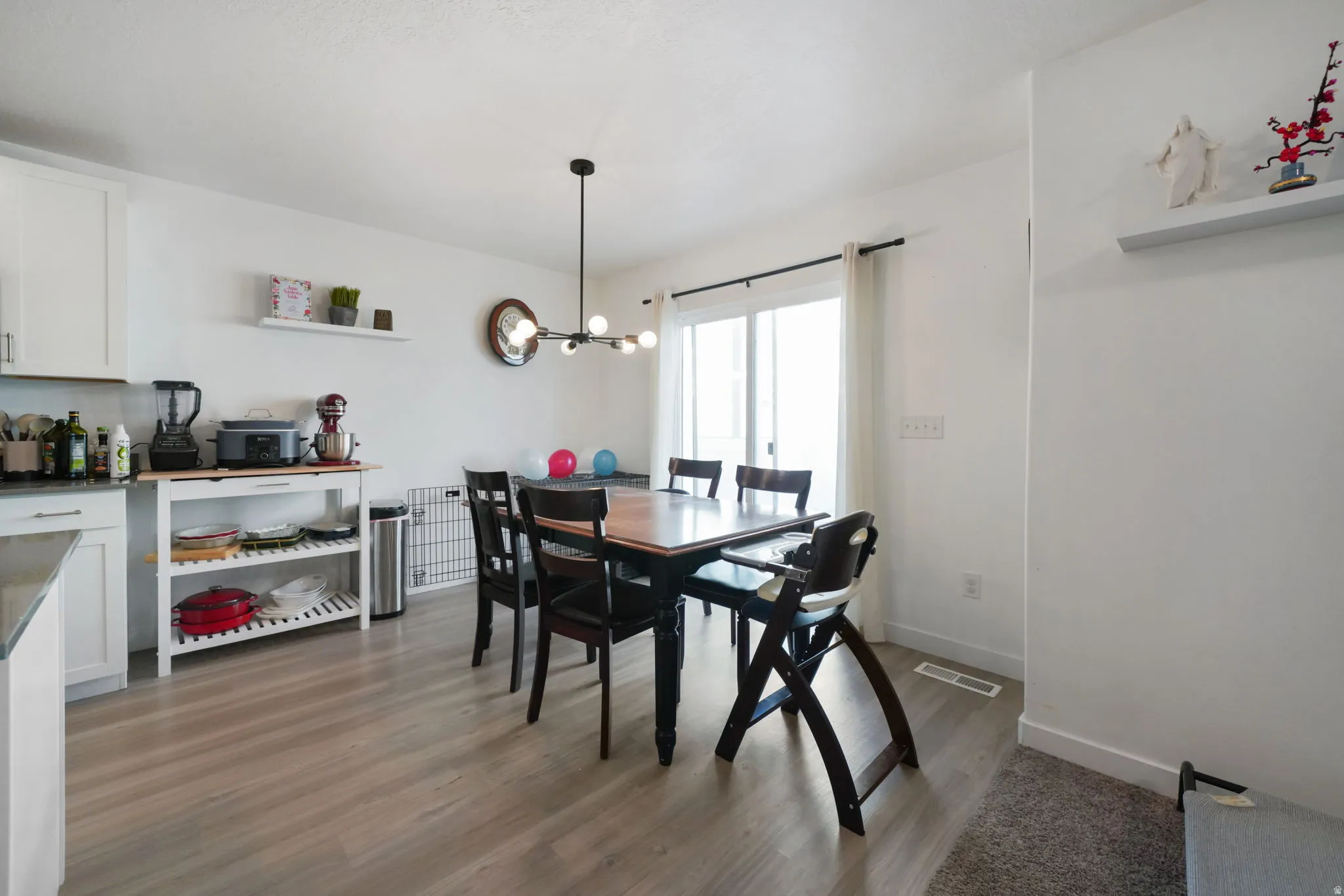 Dining area featuring a chandelier and light wood-type flooring
