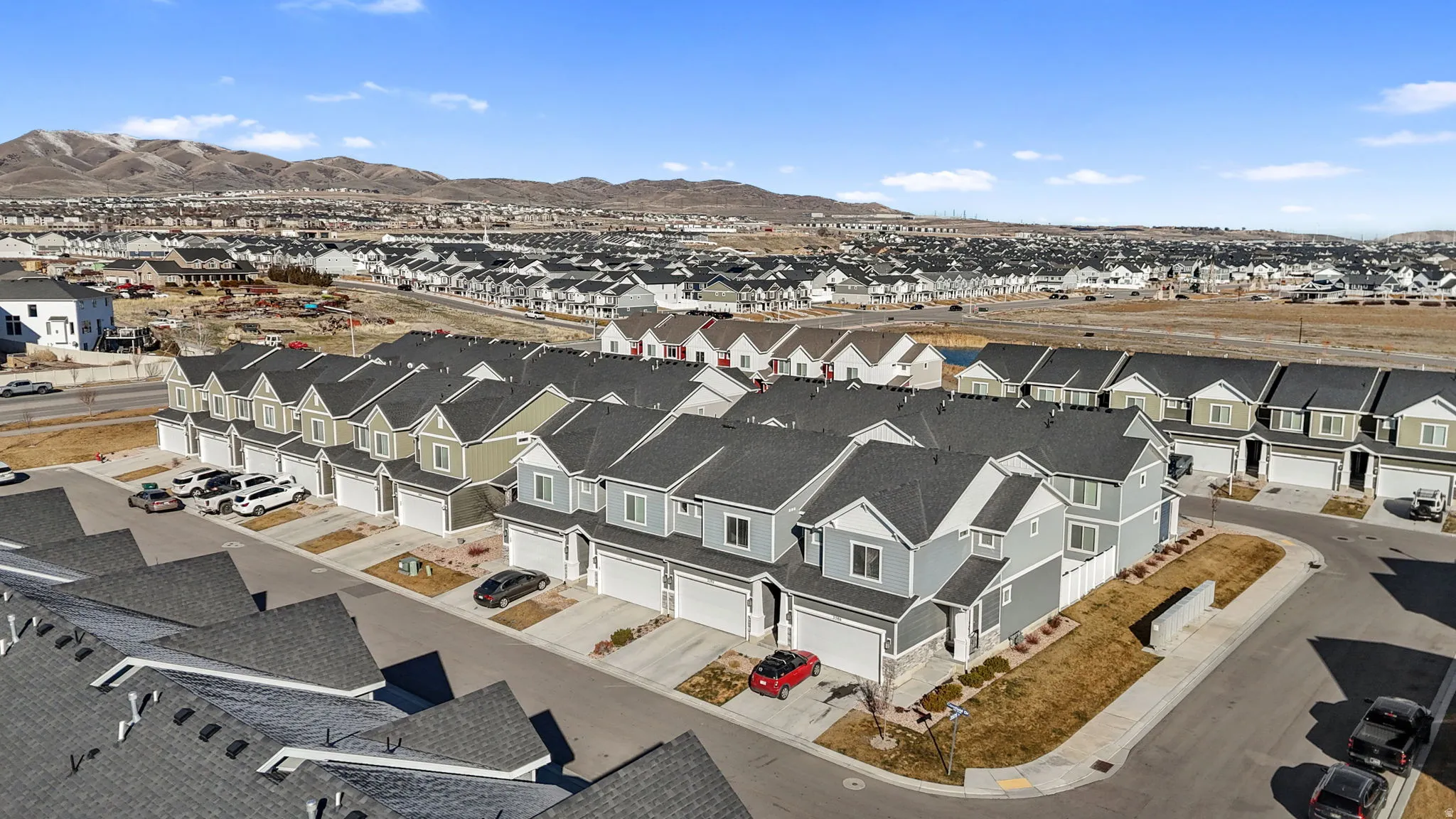 Aerial perspective of suburban area with a mountainous background