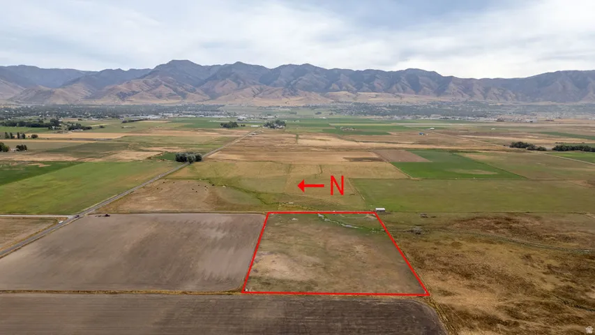 Aerial view of sparsely populated area featuring mountains and property parcel outlined