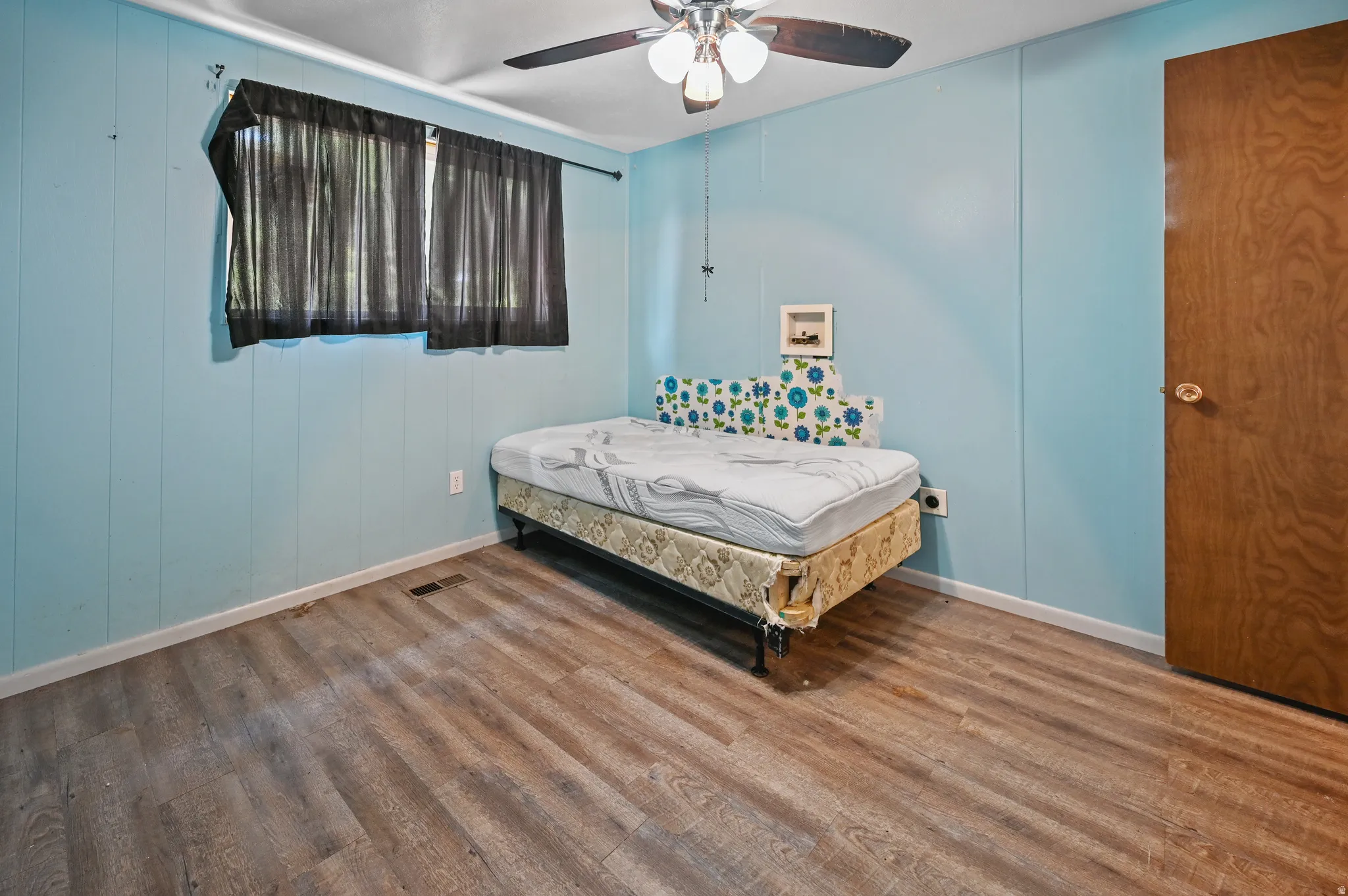 Bedroom with wood finished floors and ceiling fan