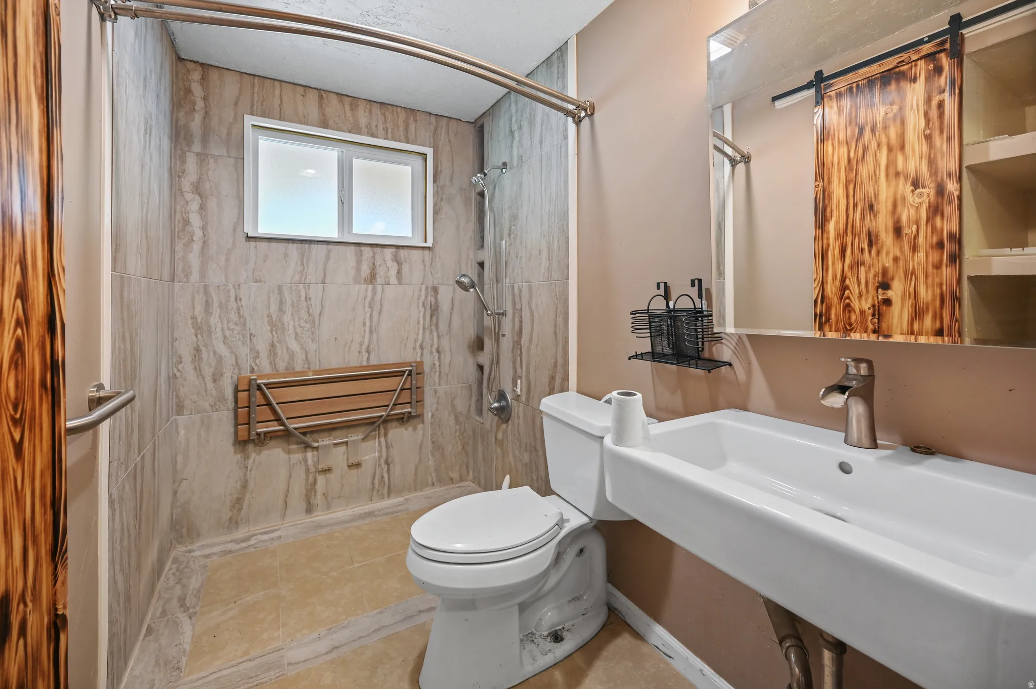 Full bath featuring toilet and a shower