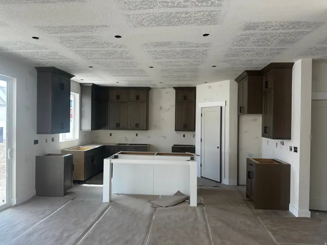 Kitchen featuring dark wood finish cabinetry, a kitchen island, and concrete flooring