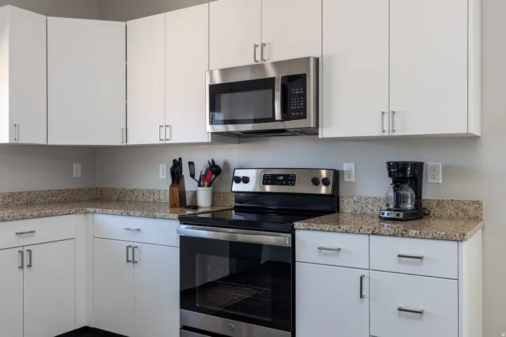 Kitchen with stainless steel appliances and white cabinetry