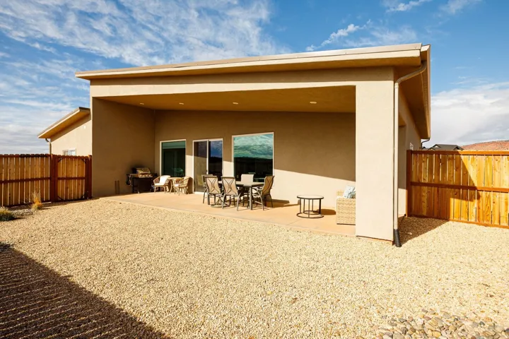 Rear view of property with a patio area, stucco siding, and a fenced backyard