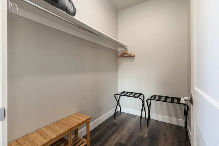 Walk in closet featuring dark wood-type flooring