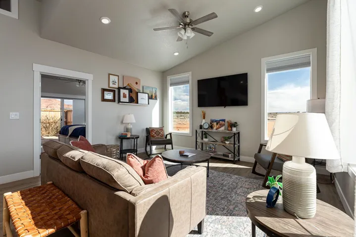 Living room with a ceiling fan, recessed lighting, vaulted ceiling, and wood finished floors