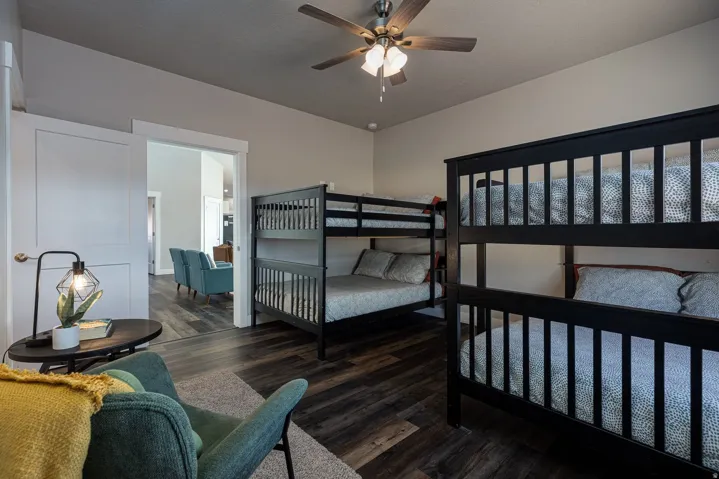 Bedroom with dark wood finished floors and a ceiling fan