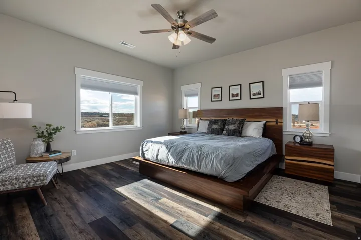 Bedroom featuring dark wood-style floors and ceiling fan