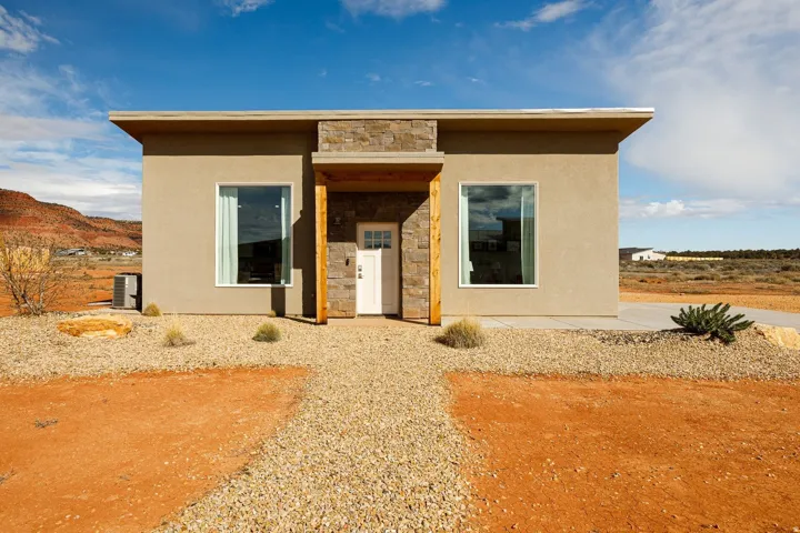 View of front facade featuring stone siding, stucco siding, and a mountain view