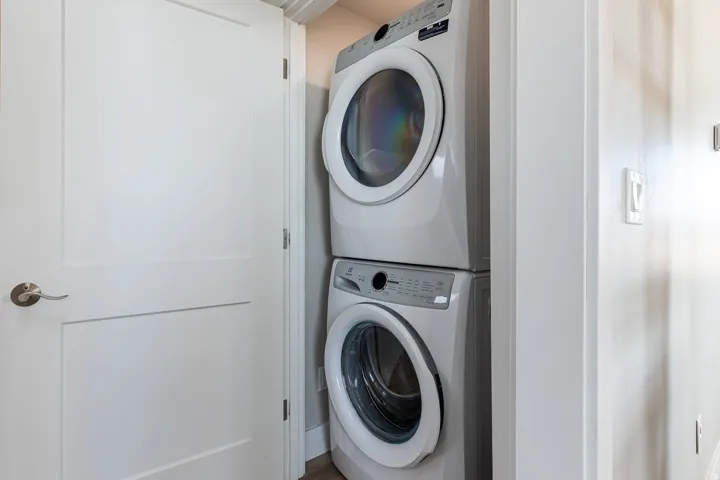 Laundry area featuring stacked washer and dryer