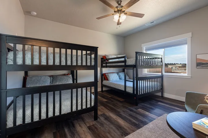 Bedroom with dark wood-style flooring, ceiling fan, and a textured ceiling