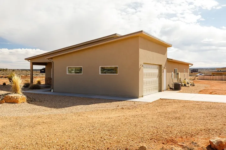 View of home's exterior with concrete driveway, stucco siding, and a garage