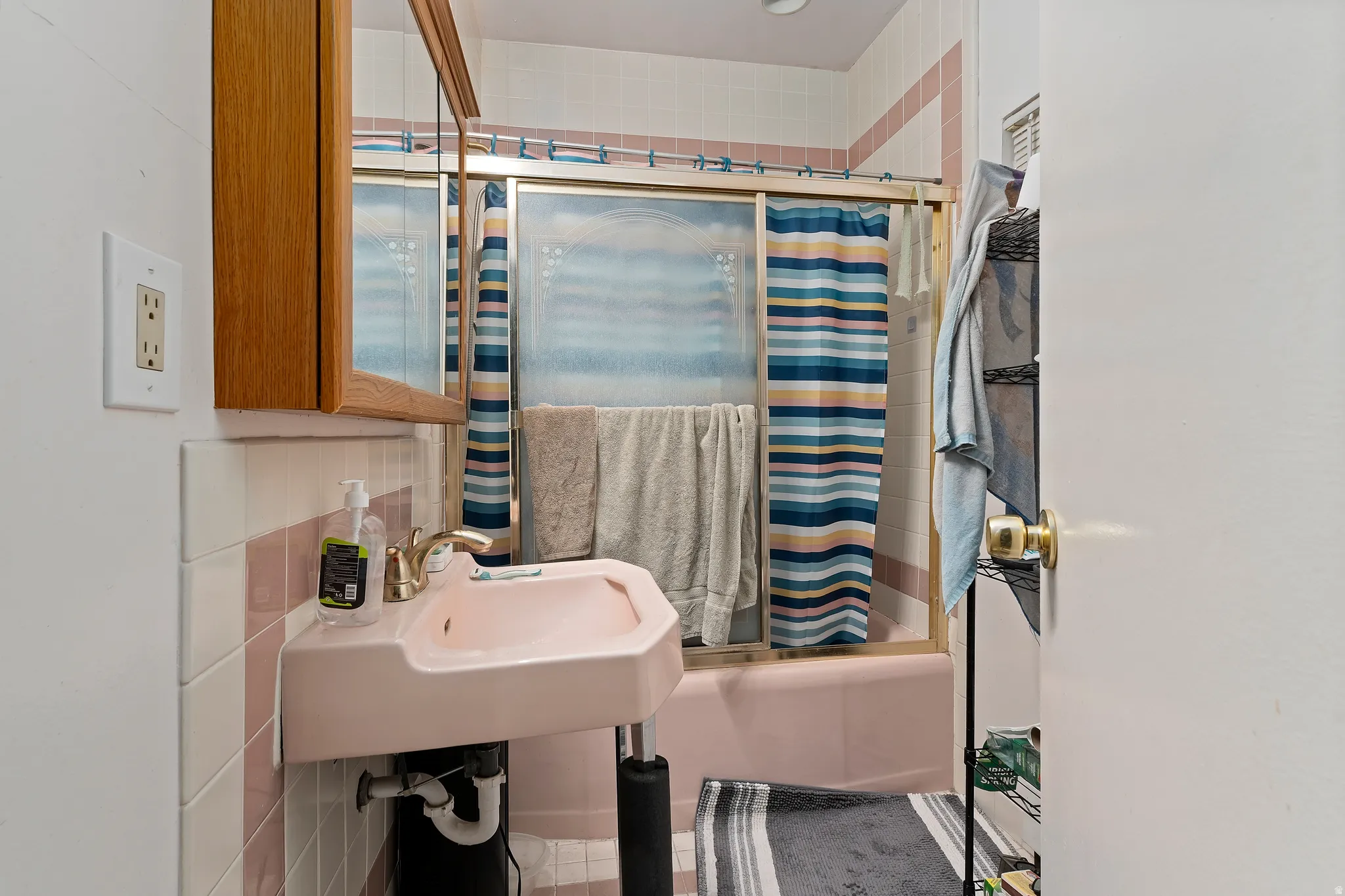 Full bath with shower / bath combination with glass door