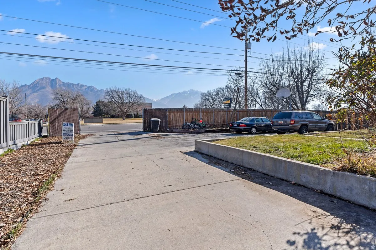 View of concrete driveway with a mountain view