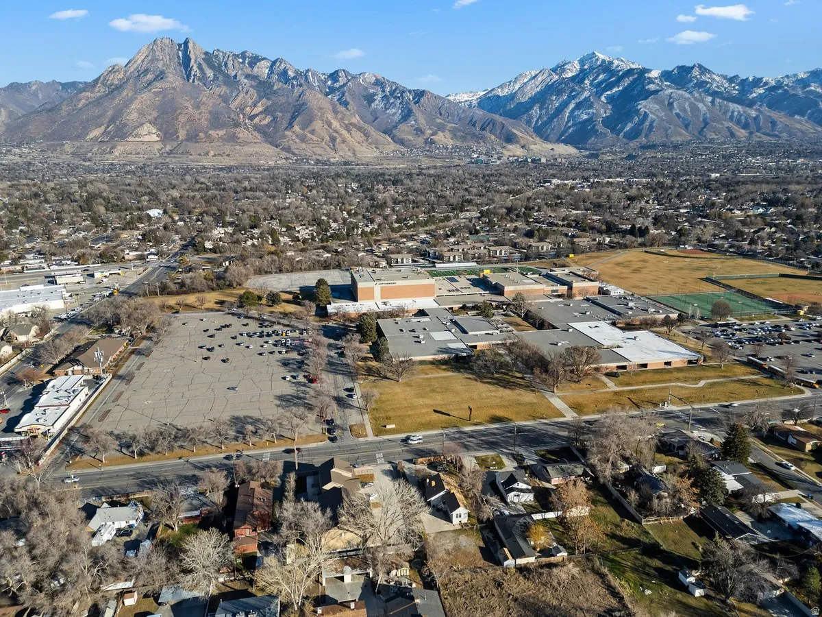 Aerial overview of property's location with a mountainous background and nearby suburban area
