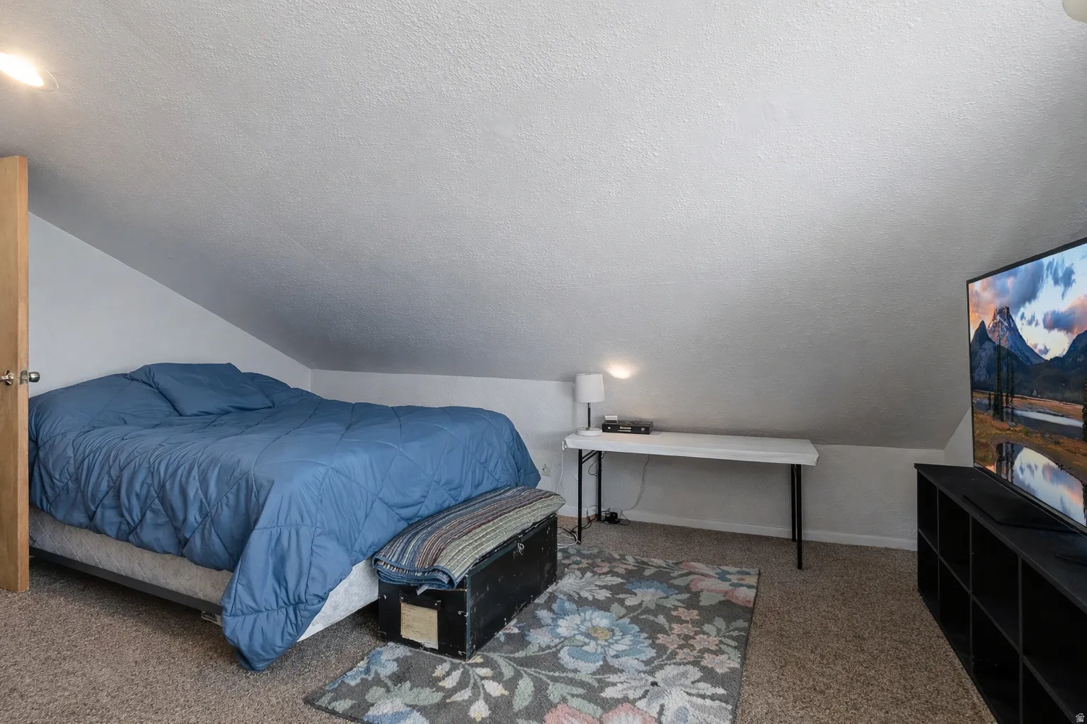Bedroom with carpet flooring and baseboards