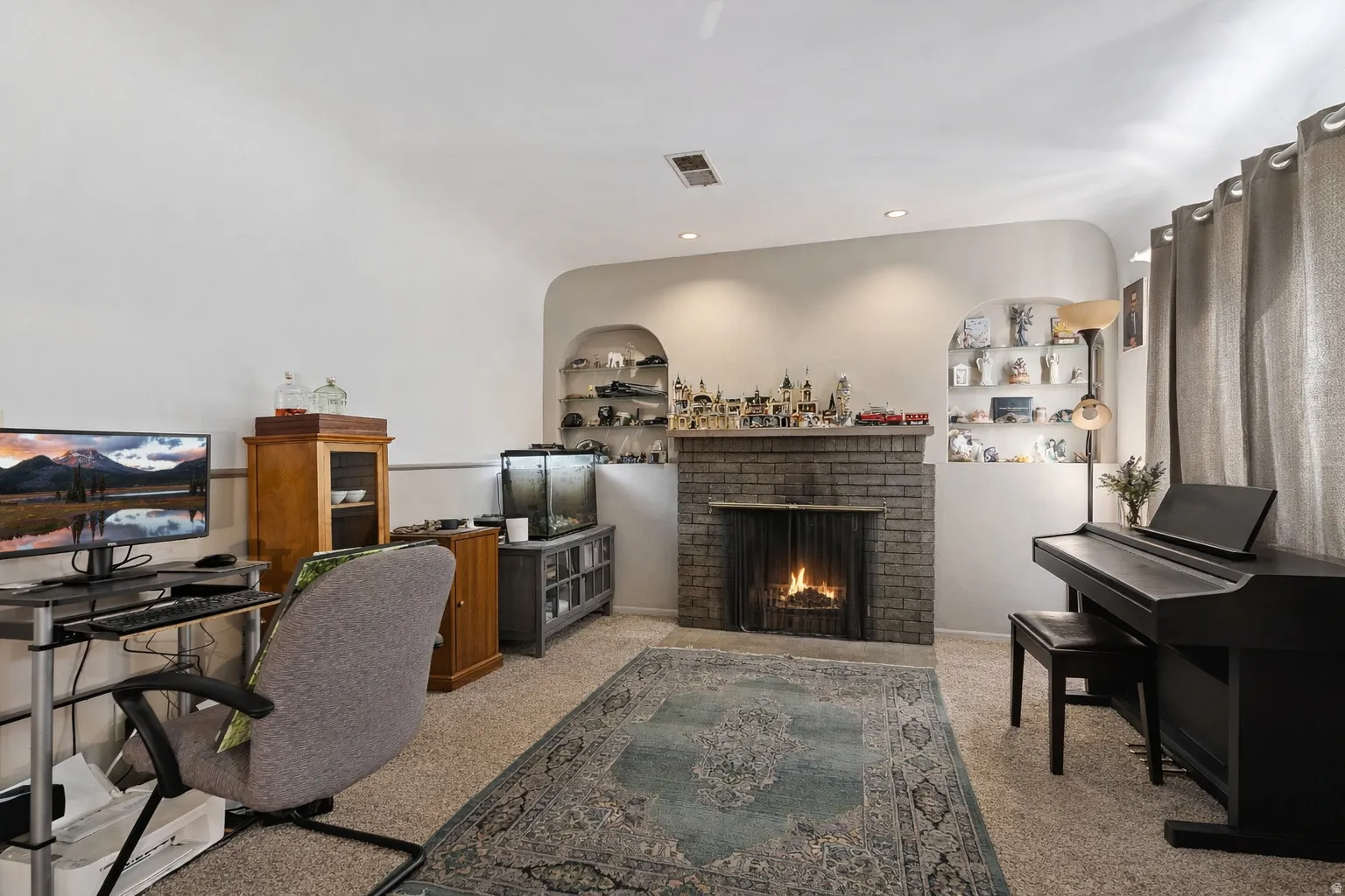 Office space featuring built in features, a fireplace, recessed lighting, and light colored carpet