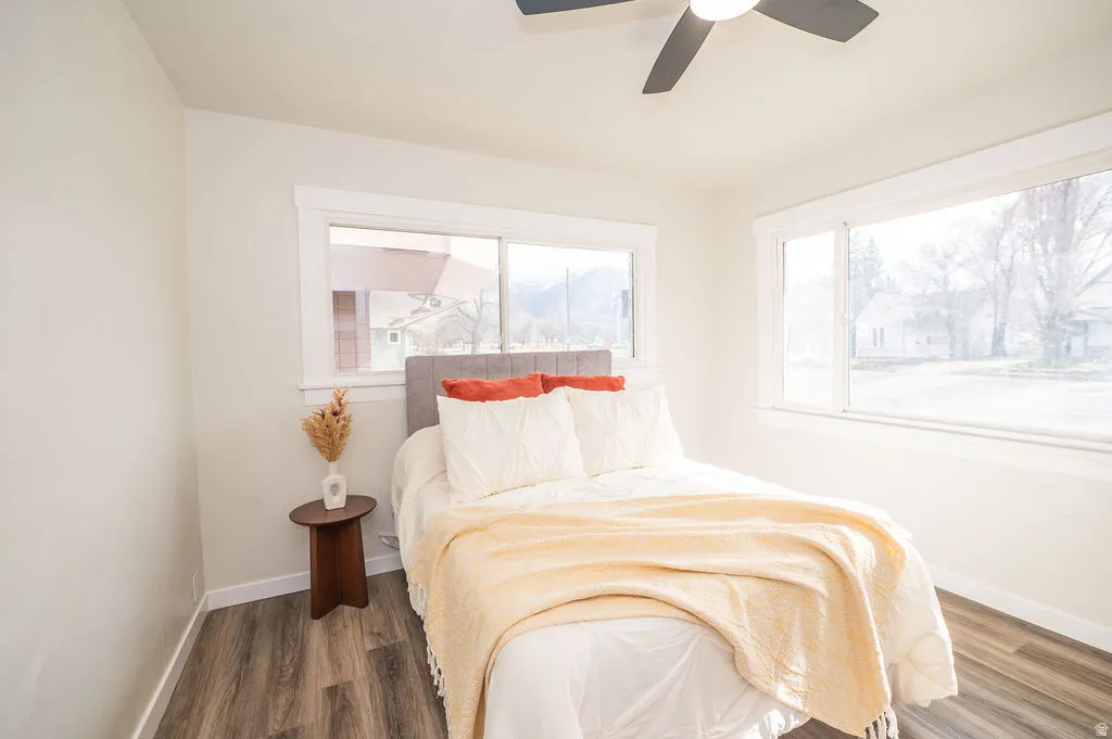 Bedroom featuring dark wood-style flooring and ceiling fan