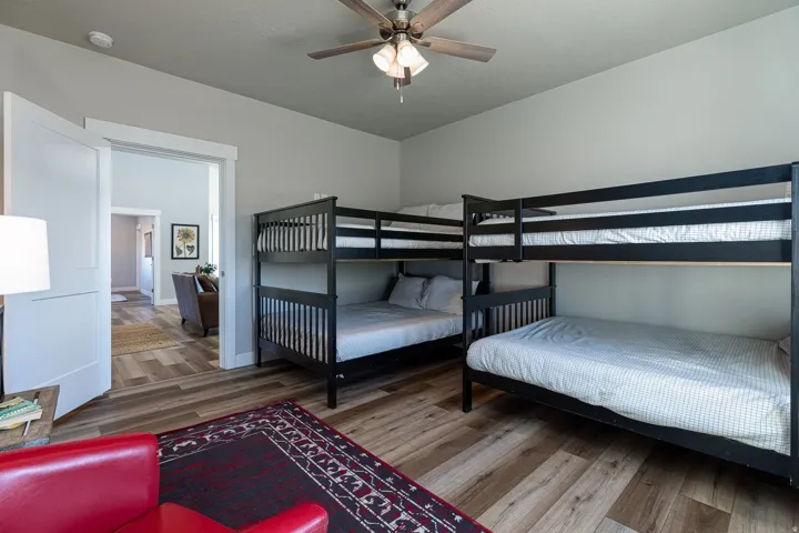 Bedroom featuring wood finished floors and a ceiling fan
