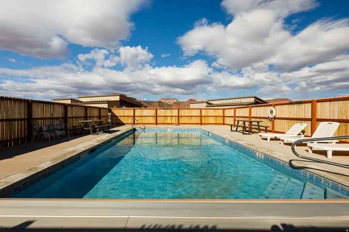Community pool featuring a fenced backyard and a patio