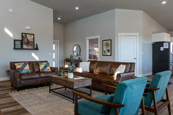 Living area featuring wood finished floors, a high ceiling, and recessed lighting