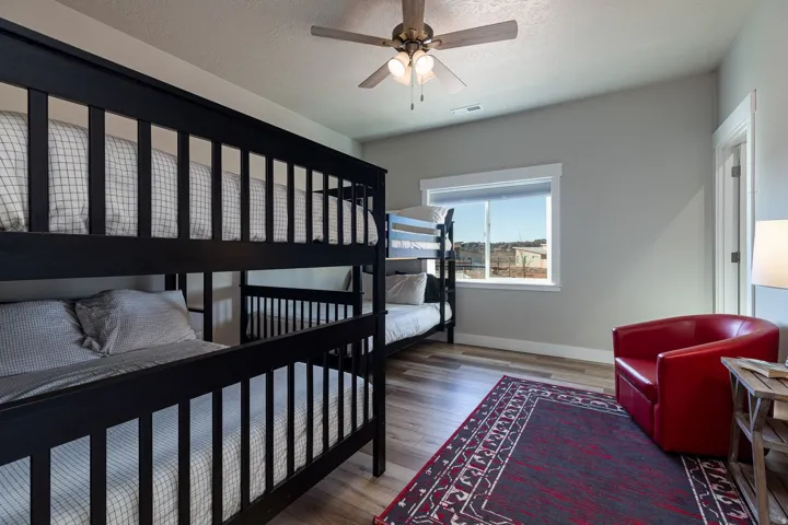 Bedroom featuring wood finished floors, ceiling fan, and a textured ceiling