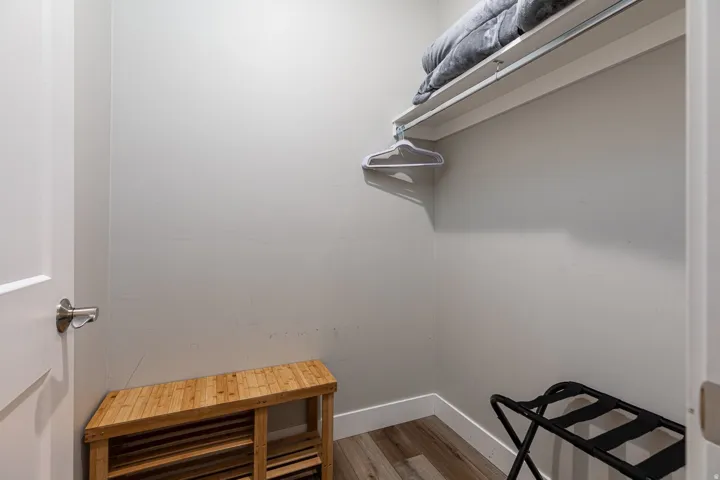 Walk in closet with wood finished floors