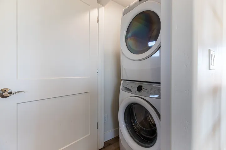 Laundry area featuring stacked washer / drying machine