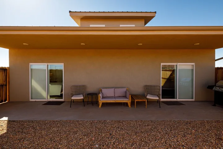 Back of property featuring a patio area and stucco siding