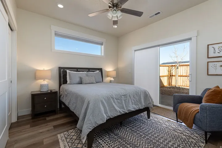 Bedroom with wood finished floors, ceiling fan, access to outside, recessed lighting, and a closet