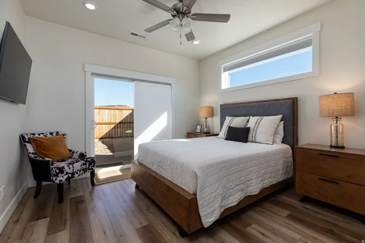 Bedroom with wood-type flooring, ceiling fan, and recessed lighting