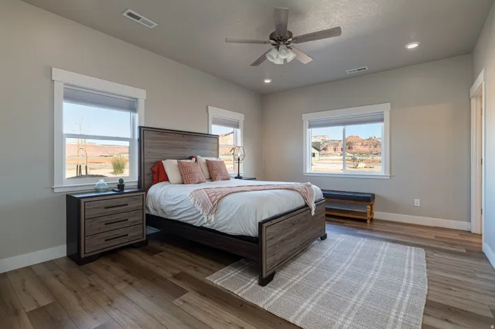 Bedroom with hardwood / wood-style flooring, a ceiling fan, and recessed lighting