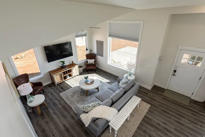 Living room featuring dark wood-style flooring and baseboards