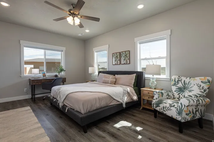 Bedroom with wood finished floors, ceiling fan, and recessed lighting