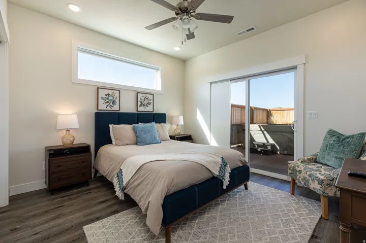 Bedroom with access to exterior, dark wood-style flooring, ceiling fan, and recessed lighting