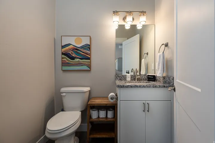 Half bathroom featuring vanity and toilet