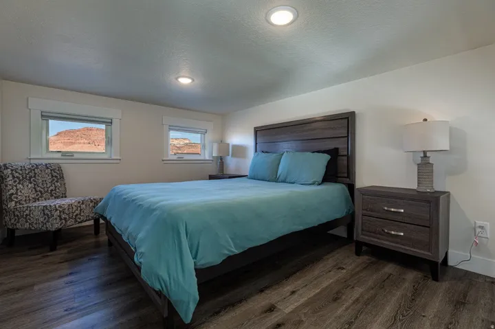 Bedroom with a textured ceiling and dark wood-style flooring
