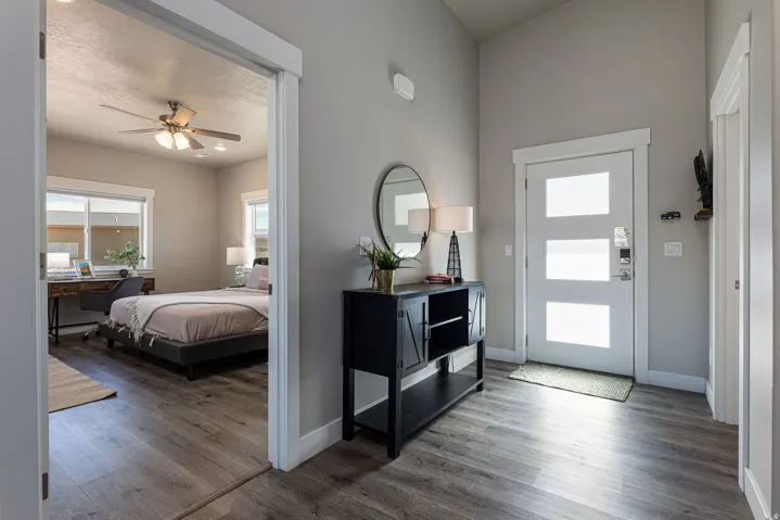 Entrance foyer with dark wood-style floors and ceiling fan